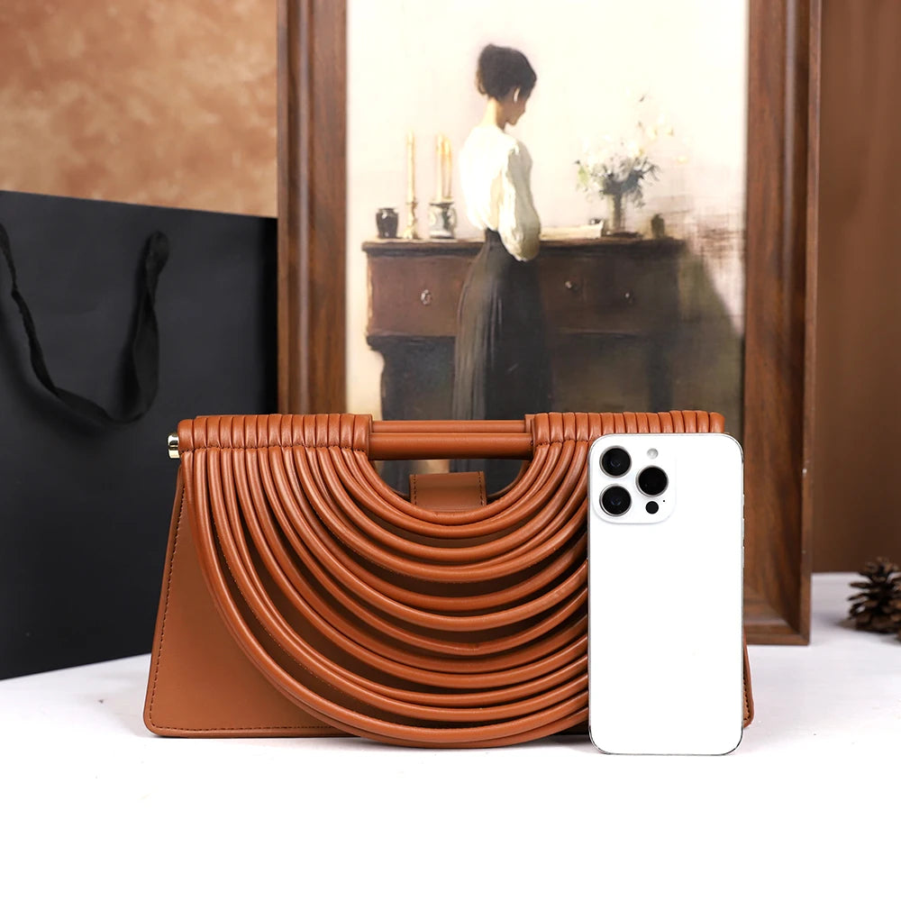 The 2025 new hand-held woven bag with lines is a unique, high-end, individual and fashionable handbag for women