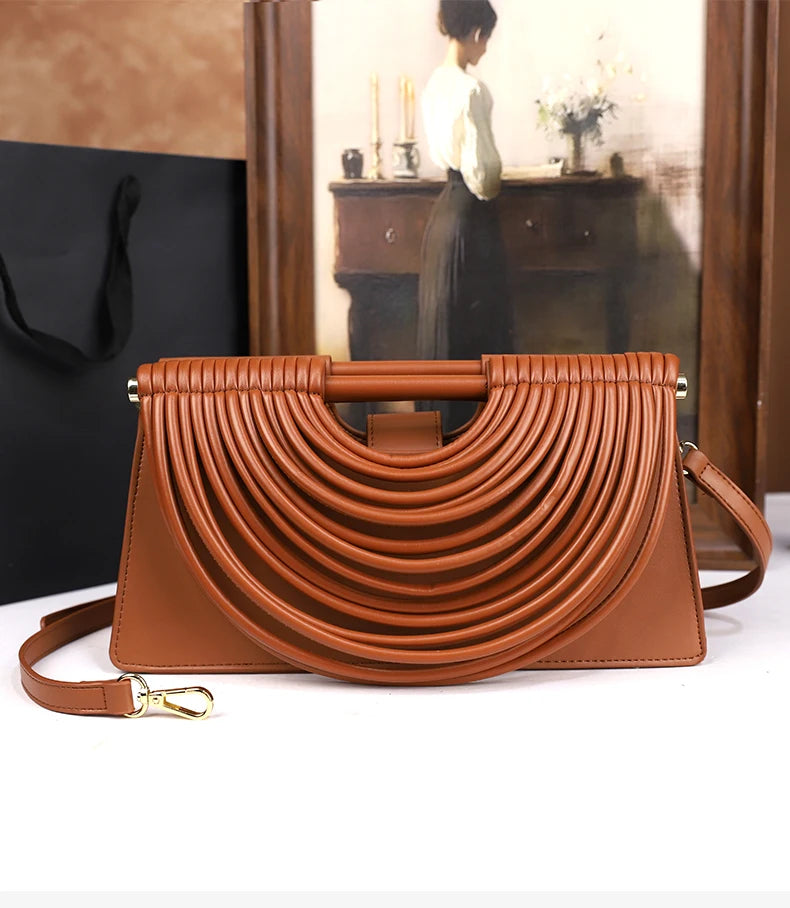 The 2025 new hand-held woven bag with lines is a unique, high-end, individual and fashionable handbag for women
