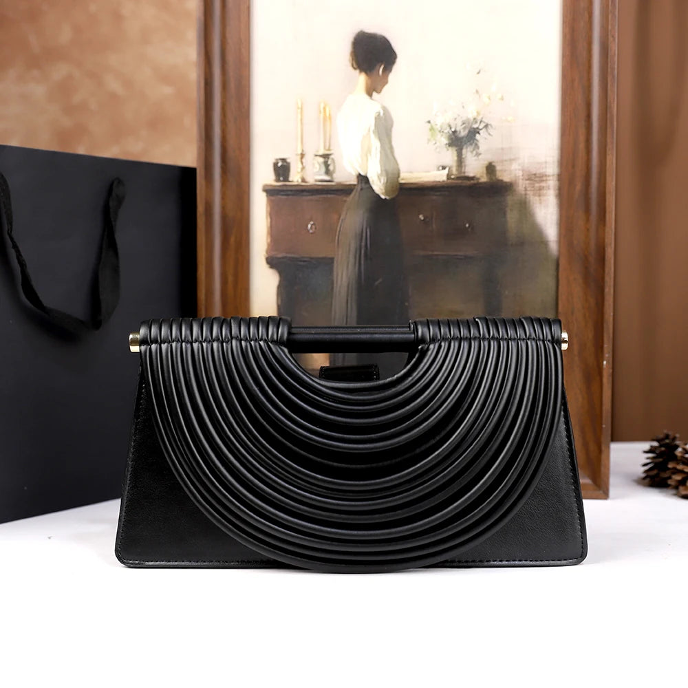 The 2025 new hand-held woven bag with lines is a unique, high-end, individual and fashionable handbag for women