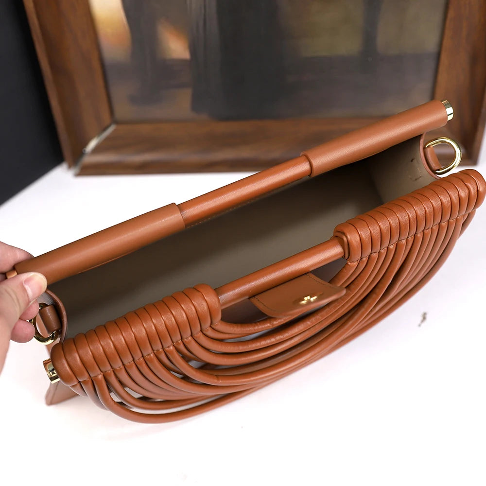 The 2025 new hand-held woven bag with lines is a unique, high-end, individual and fashionable handbag for women