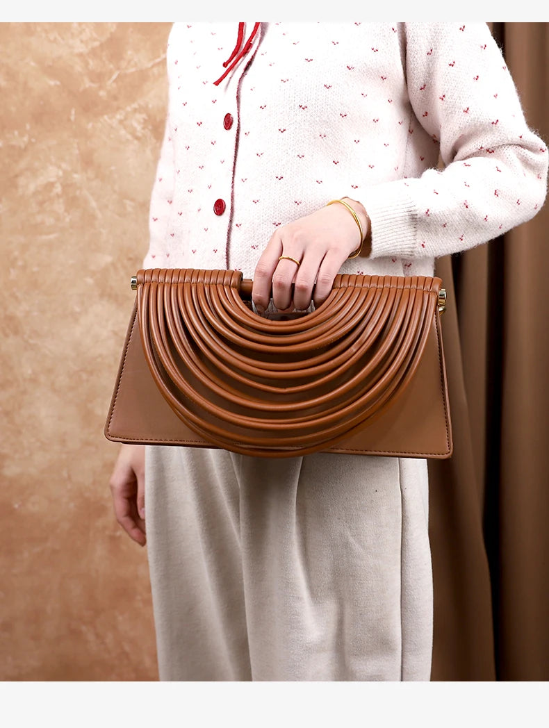 The 2025 new hand-held woven bag with lines is a unique, high-end, individual and fashionable handbag for women