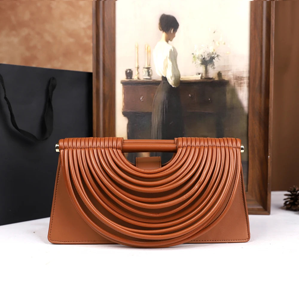 The 2025 new hand-held woven bag with lines is a unique, high-end, individual and fashionable handbag for women