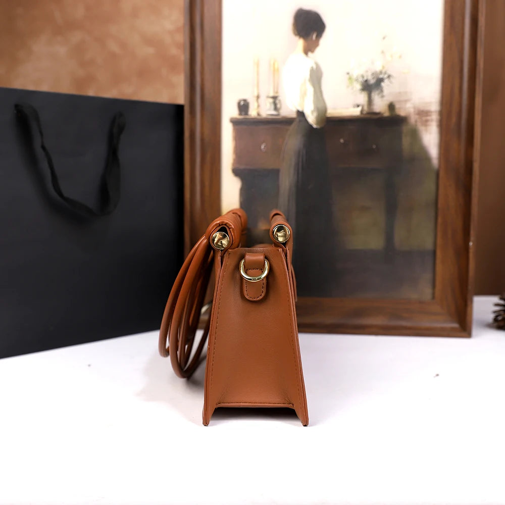 The 2025 new hand-held woven bag with lines is a unique, high-end, individual and fashionable handbag for women
