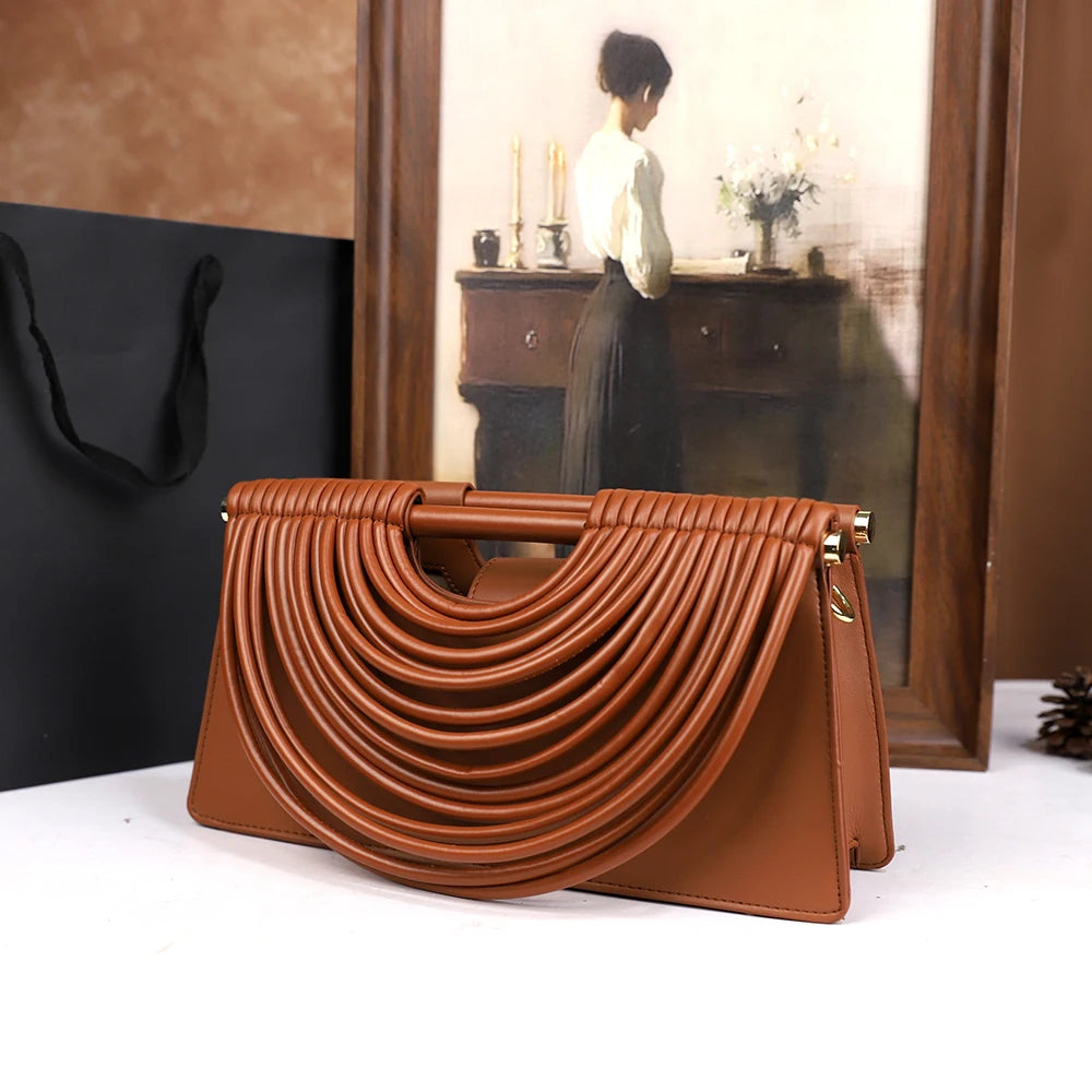 The 2025 new hand-held woven bag with lines is a unique, high-end, individual and fashionable handbag for women